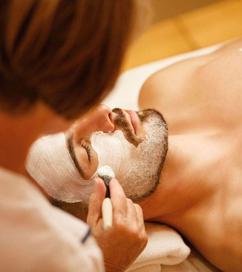 relaxed-man-getting-facial-mask-during-cosmetic-treatment-spa-salon-min